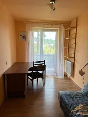 a room with a desk and a chair and a window at Ramybės kotedžas in Kaunas