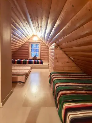 a room with two beds in a log cabin at Prienų vienkiemis in Kelmė