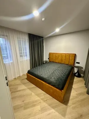 a bedroom with a wooden bed in a room at Butas nuomai truputį daugiau nei kilometras pėsčiomis iki Senamiesčio in Kaunas