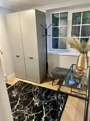 a living room with a glass table and a vase on a table at Butas nuomai truputį daugiau nei kilometras pėsčiomis iki Senamiesčio in Kaunas