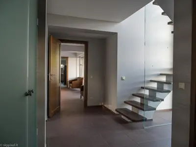 a hallway with a staircase in a house at Villa Emilė in Kontverki