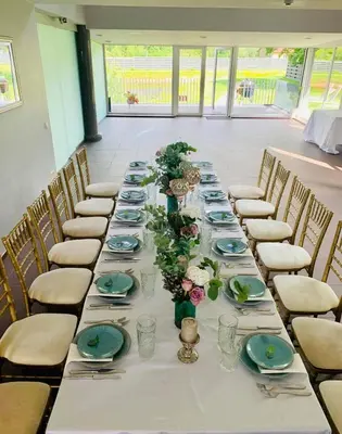 a long table with plates and flowers on it at Villa Emilė in Kontverki