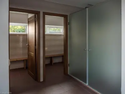 a hallway with two doors and two windows in a room at Villa Emilė in Kontverki
