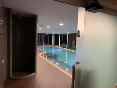 a swimming pool in the middle of a building at Villa Emilė in Kontverki