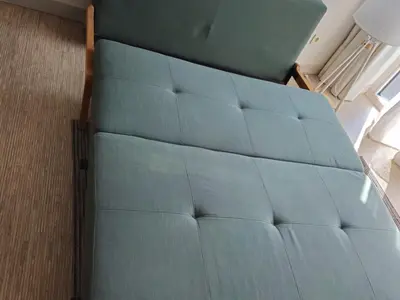 a bed with blue sheets in a room at HaPPy Inn PLENTIFUL OLD Town Studio, Self check-in, AC, Parking in the underground Garage in Vilnius