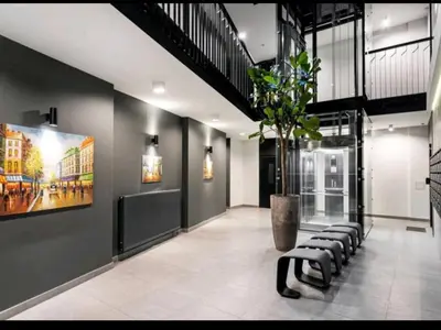 a lobby with a row of benches and a potted plant at HaPPy Inn PLENTIFUL OLD Town Studio, Self check-in, AC, Parking in the underground Garage in Vilnius