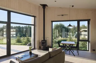 a living room with a couch and a table at Juoda Truoba