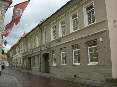a building with a flag on the side of a street at Litinterp in Vilnius