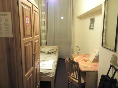 a small room with two beds and a table at Litinterp in Vilnius