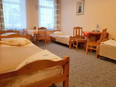 a room with four beds and chairs and a table at Litinterp in Vilnius