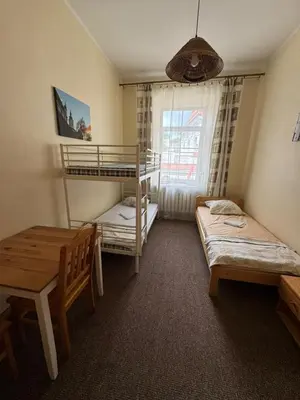 a bedroom with two bunk beds and a table at Litinterp in Vilnius