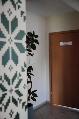 a hallway with a plant next to a door at GP Hostel in Šiauliai