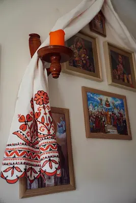 a lamp hanging on a wall with pictures at GP Hostel in Šiauliai