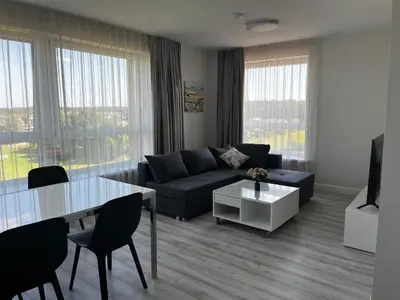 a living room with a couch and a table at Buto nuoma Druskininkuose in Druskininkai