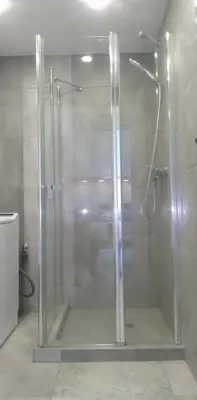 a shower with a glass door in a bathroom at Buto nuoma Druskininkuose in Druskininkai