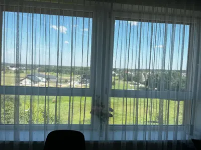 a large window with a view of a field at Buto nuoma Druskininkuose in Druskininkai