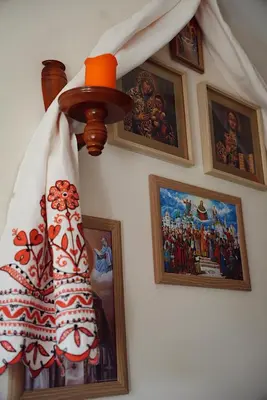 a room with pictures on the wall and a lamp at GP Hostel in Šiauliai