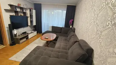 a living room with a couch and a table at Weekend Home in Visaginas