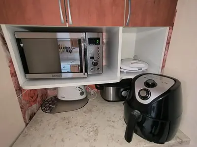 a microwave oven sitting on top of a counter at Weekend Home in Visaginas