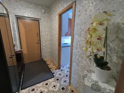 a room with a mirror and a vase with flowers at Weekend Home in Visaginas