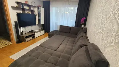 a living room with a couch and a flat screen tv at Weekend Home in Visaginas