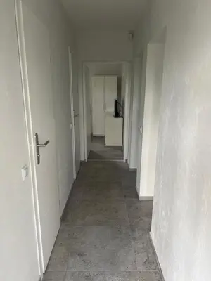 an empty hallway with a hallway leading into a room at Pušų Sodas in Birštonas