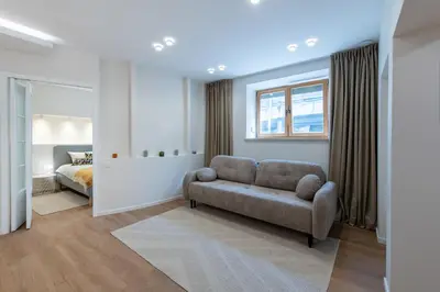 a living room with a couch and a bed at Opera Escape Studio in Vilnius