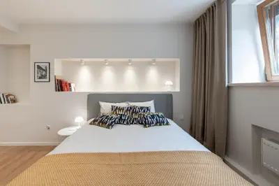 a bedroom with a large white bed with pillows at Opera Escape Studio in Vilnius