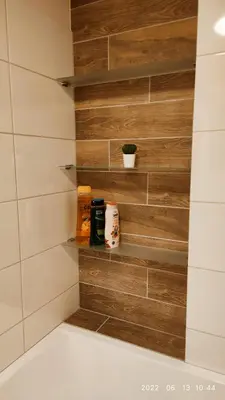 a bathroom with a wall of wooden tiles at HaPPy Inn Egle,Self check-in,AC, Parking in garage in Vilnius