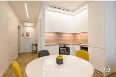 a kitchen with a white table and yellow chairs at HaPPy Inn Egle,Self check-in,AC, Parking in garage in Vilnius