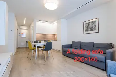a living room with a blue couch and a table at HaPPy Inn Egle,Self check-in,AC, Parking in garage in Vilnius