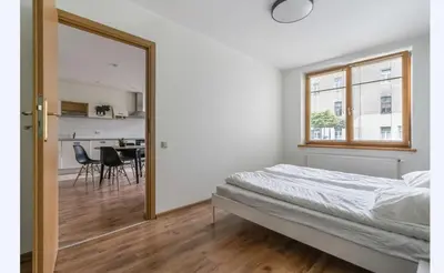 a bedroom with a mirror and a table with chairs at Amber Self Check-in Oldtown in Vilnius