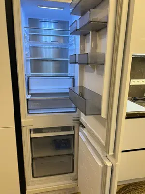 an empty refrigerator with its door open in a kitchen at Nemuno Banga in Druskininkai