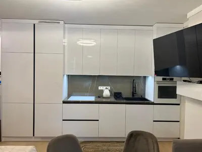 a kitchen with white cabinets and a counter top at Nemuno Banga in Druskininkai