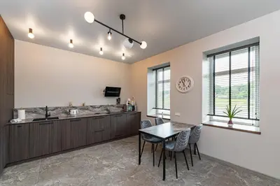 a kitchen and dining room with a table and chairs at MnW apartment by Polo Apartments in Kaunas