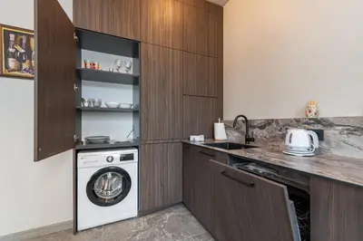 a kitchen with a washer and a washing machine at MnW apartment by Polo Apartments in Kaunas
