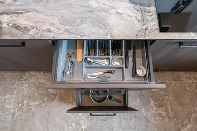 a drawer filled with tools on top of a counter at MnW apartment by Polo Apartments in Kaunas