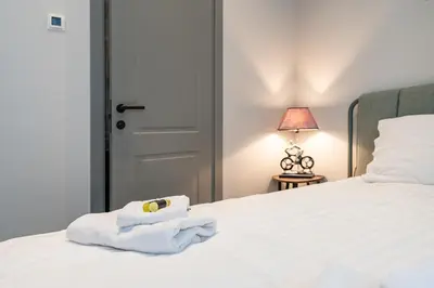 a bedroom with a bed with white towels on it at MnW apartment by Polo Apartments in Kaunas