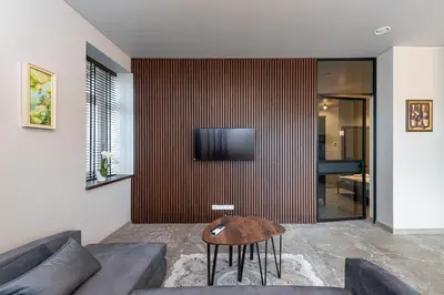 a living room with a couch and a tv on a wall at MnW apartment by Polo Apartments in Kaunas