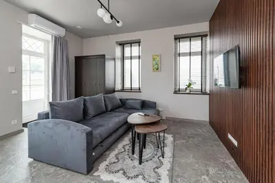 a living room with a blue couch and a table at MnW apartment by Polo Apartments in Kaunas