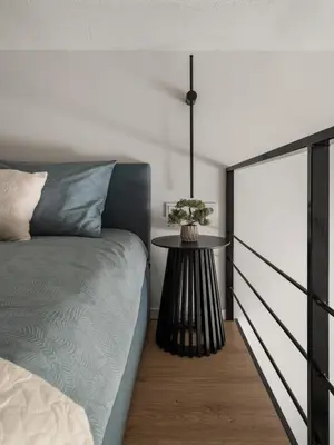 a bedroom with a bed and a table at Loft 13 in Vilnius