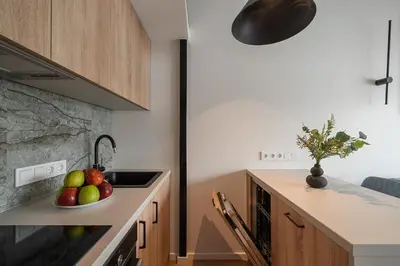 a kitchen with a bowl of fruit on a counter at Loft 13 in Vilnius