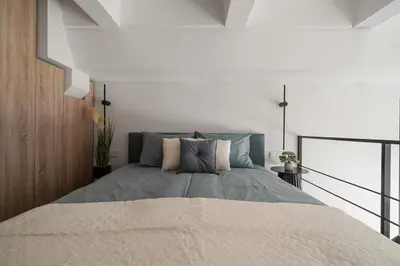 a bedroom with a large bed in a room at Loft 13 in Vilnius