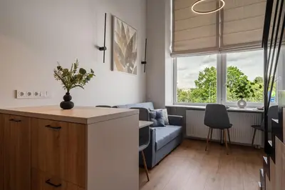 a living room with a couch and a blue sofa at Loft 13 in Vilnius