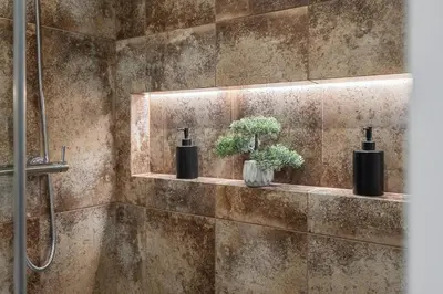 a bathroom with two vases with plants on a wall at Loft 14 in Vilnius