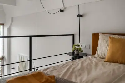 a bedroom with a bed and a large window at Loft 14 in Vilnius