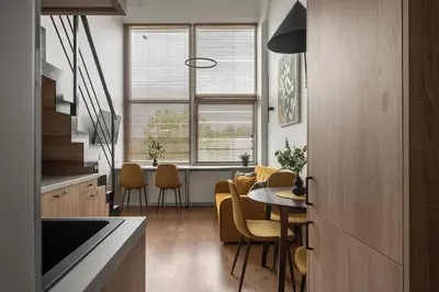 a kitchen and dining room with a table and chairs at Loft 14 in Vilnius