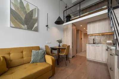 a living room with a couch and a table at Loft 14 in Vilnius
