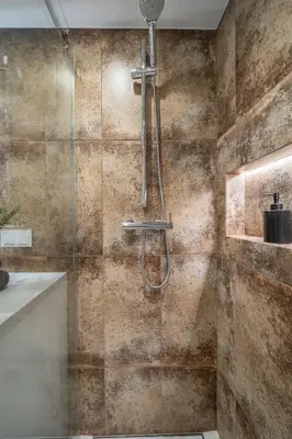 a shower with a glass door in a bathroom at Loft 14 in Vilnius