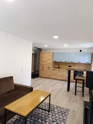 a living room with a couch and a table at Alytus Miško studio in Alytus